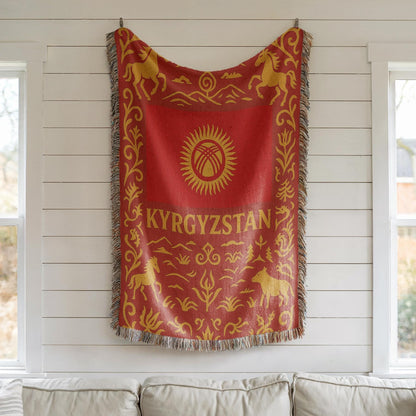 Red and gold Kyrgyzstan woven blanket with horses, mountains, ornamental borders, and fringe edges